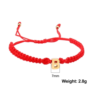 Detail of red braided cord bracelet featuring a 7mm golden letter B charm and metal beads