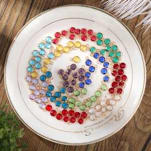 Macro detail of 6mm faceted birthstone glass pendants in assorted colors with gold frames