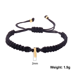 Detail of 2mm rectangular gold pendant on black braided rope bracelet weighing 1.9g