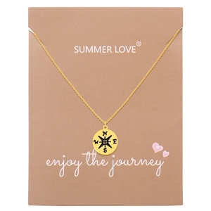Golden stainless steel compass pendant necklace displayed on an original kraft gift card