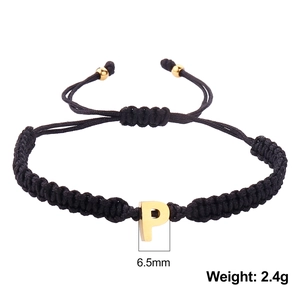 Detail of hand-woven black string bracelet with golden P-letter charm and size dimensions