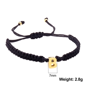 Adjustable black woven rope bracelet with gold letter B pendant and metal beads