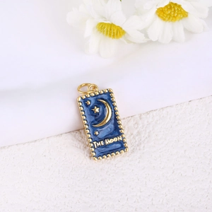 Detail of The Moon tarot card pendant in gold plated copper with blue enamel and stars