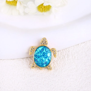 Detailed view of turtle pendant with blue opal shell and crystal embellishments