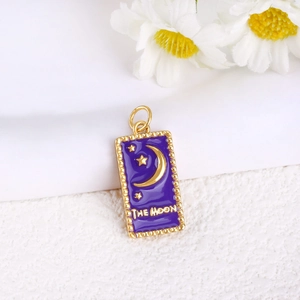 Detailed view of The Moon tarot pendant with purple enamel and gold moon star motifs