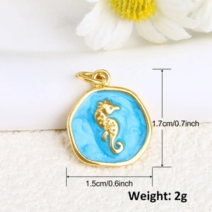 Detailed macro view of gold-plated seahorse charm with blue enamel and dimensions
