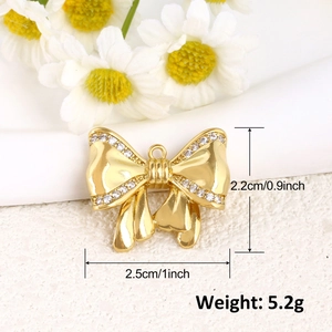 Détails d'un pendentif nœud doré serti de zircons, dimensions de 2,5 cm sur 2,2 cm