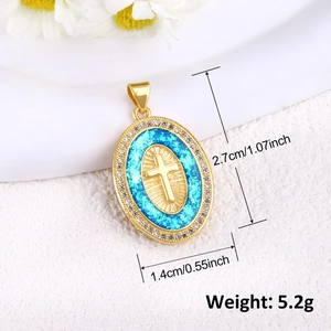 Detail shot of a gold-plated oval cross pendant with blue inlay and cubic zirconia