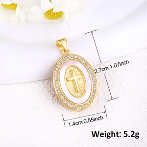 Detailed size view of a gold-plated oval cross pendant with white inlay and crystals
