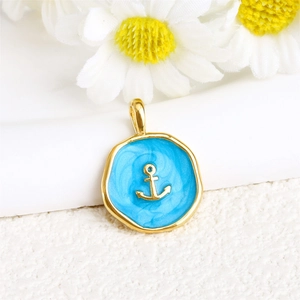 Detail of nautical anchor pendant with blue enamel and gold-plated irregular frame