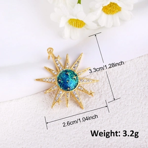 Gold-plated starburst pendant with blue celestial center and white zircon stones