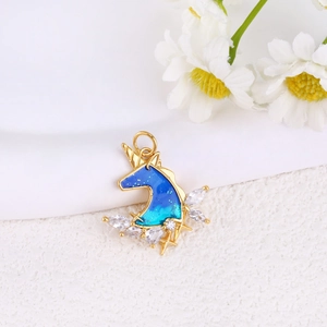 Detailed close-up of unicorn pendant with blue starry oil drip and shiny zircon accents