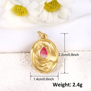 Macro shot of gold tulip charm with pink enamel detail and product dimensions in cm and inch