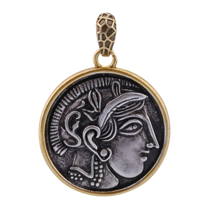 Macro view of vintage coin pendant with Greek goddess relief and gold textured clasp