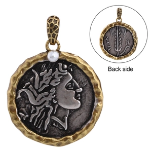 Detail of vintage relief coin pendant with pearl accent showing front and back views