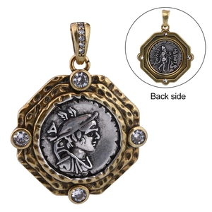Detail of vintage coin pendant with dual-sided engraving and zircon inlays on white background