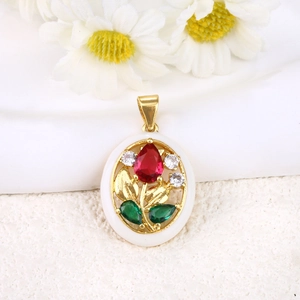 Macro view of oval gold-plated tulip pendant with red gems and crystal accents