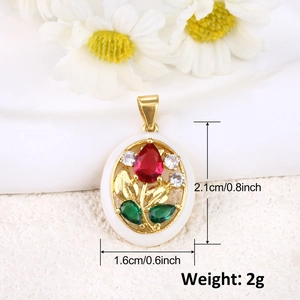 Detailed view of oval gold tulip pendant with ruby and emerald zircon on white texture