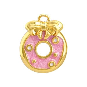 Détail d'un pendentif donut rose pailleté avec nœud doré pour la création de bijoux