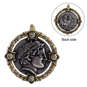 Detail of vintage coin pendant with greek portrait relief and crystal embellishments