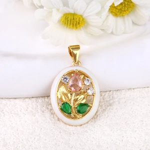 Detail of floral pendant with pink and green gemstones on polished gold base