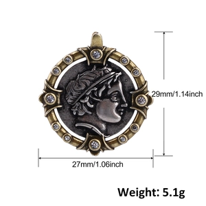 Close-up of vintage coin pendant with relief portrait and sparkling rhinestones