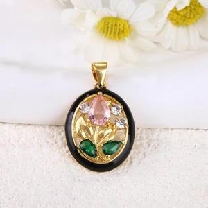 Detailed view of vintage gold-plated tulip pendant with enamel and zircon inlay