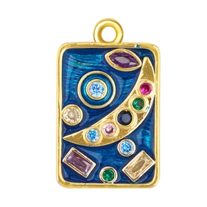 Macro detail of rectangle gold plated pendant with blue enamel and colorful gemstones