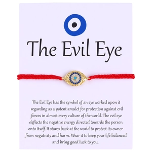 Evil Eye braided red cord bracelet with gold plated diamond palm charm on display card