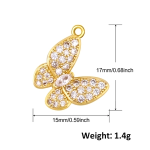 Detailed view of a gold butterfly pendant with crystals, sized 17mm x 15mm and 1.4g weight