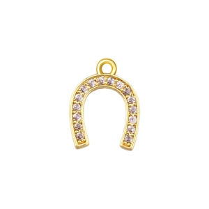 Detailed view of horseshoe charm pendant with gold plating and cubic zirconia inlay