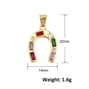 Macro detail of gold horseshoe pendant with multicolored zircon and 22mm x 14mm dimensions