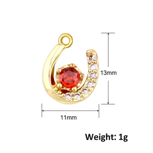 Detail of horseshoe pendant with red zircon and white stones showing 13mm size