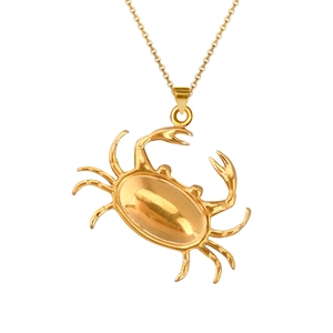 Detailed view of polished gold crab pendant necklace with delicate chain link detail