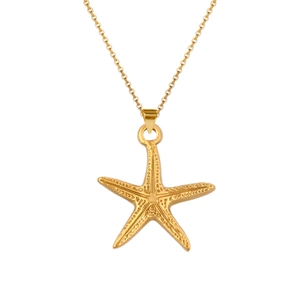 Close-up of a gold starfish pendant necklace showing detailed dotted texture