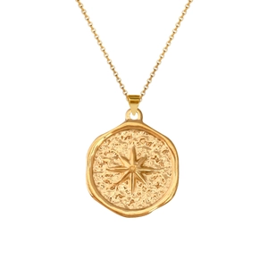 Detail of gold coin necklace with hammered texture and sunburst star pendant on fine chain