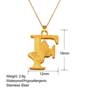 Detailed view of 18K gold letter F pendant with butterfly relief and size markers