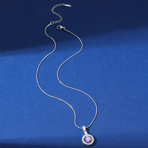 Elegant silver necklace with a purple zircon circular pendant on a snake bone chain