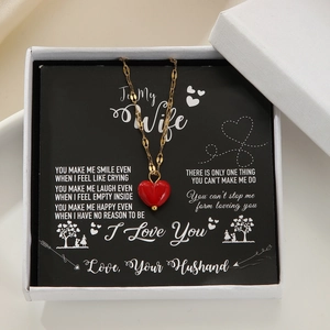 Red heart pendant necklace in a gift box with a romantic greeting card for wife