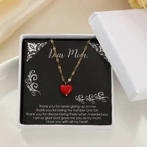 Red heart necklace in a white gift box with an English greeting card for mother