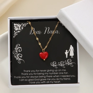 Detail of red heart pendant necklace in white gift box with Dear Nana greeting card