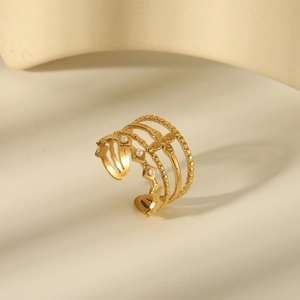 Detail of multi-layer 18K gold-plated ring featuring pearl accents and star motif