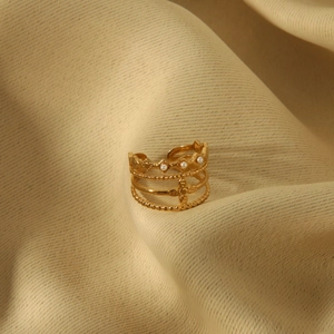 Detail of 18K gold-plated multi-layer ring with white pearls and crown engraving