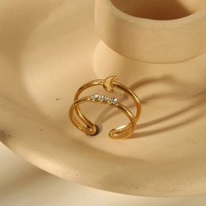 Detail of 18K gold-plated double-layer ring with moon shape and sparkling cubic zirconia