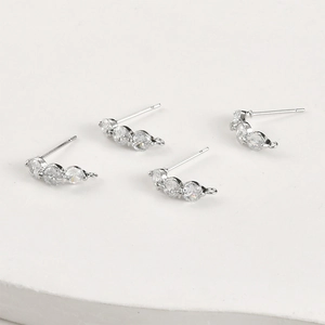 Detail of silver plated ear studs with three cubic zirconia stones and hanging loop