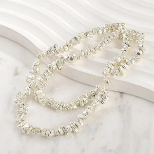 Macro view of silver irregular lava rock beads with textured metallic finish for jewelry