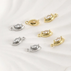 Macro detail of marquise cubic zirconia pendants in gold and silver plating for DIY jewelry