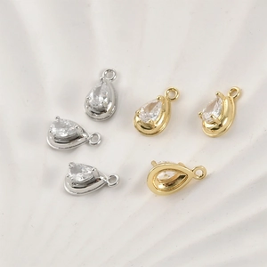 Close-up of teardrop zircon pendants in gold and silver finish for DIY jewelry