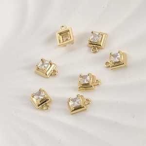Close-up of 14k gold-plated square zircon charms with four-claw setting for jewelry making