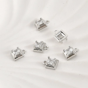 Detailed view of silver square charms with cubic zirconia for DIY jewelry making